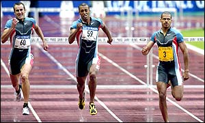 Dominican Felix Sanchez (right) gets the better of Britain's Chris Rawlinson (far left) in the men's 400m hurdles 