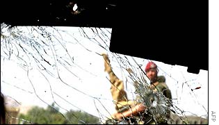 A German soldier seen through the shattered windscreen
