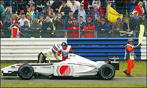 Olivier Panis hurries to push his BAR Honda to the starting grid prior to Sunday's Bristish Grand Prix