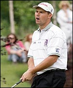 Padraig Harrington reacts as a putt slides by on the fifth