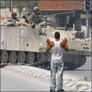 Palestinian man in front of Israeli tank