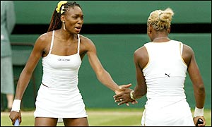 Venus congratulates Serena on a crucial point