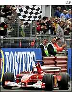 Schumacher pumps his fist after winning the British Grand Prix