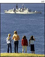 Children stand on Lord Howe Island to view the British warship 