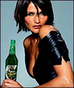Helena Christensen holds a bottle of Carlsberg