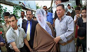 Bride is escorted from home