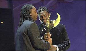Lennox Lewis (left) receives an award from Audley Harrison (right)