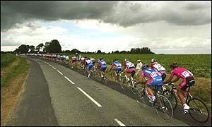 The pack rides under the shadow of dark rain clouds