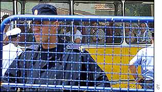 Bosnian Serb policeman at mourners' coach