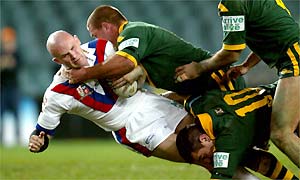 Great Britain's Keith Senior experiences first-hand the over-powering force of Australia's defence