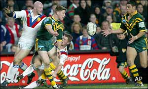 GB's Keith senior tries desperately to prevent Australia's Trent Barrett passing to team mate Timana Tahu 
