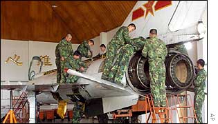 Chinese military mechanics work on a Chinese jet
