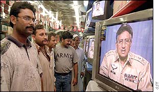 Pakistanis watch their leader General Musharraf give a televised speech 