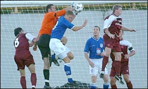 Barry keeper Simon Rayner saves over Millwall's David Livermore