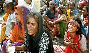 Mourning relatives of people killed in the attack in Qasim Nagar