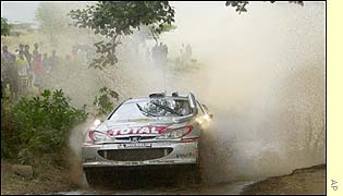 Britain's Richard Burns splashes through the water but is later forced to retire