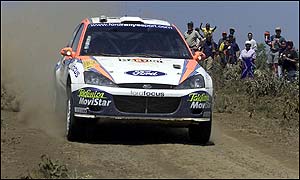 Spain's Carlos Sainz powers over the crest of a hill