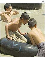 Children play in the Kabul river's dirty waters