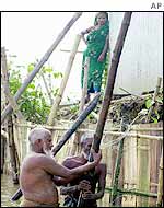 Villagers shoring up flooded home