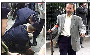French police hold down shooting suspect (l) as a police officer removes the rifle from the scene