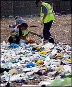 Refuse collectors and rubbish on the beach 