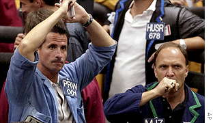 Traders react as they watch the markets drop in the Standard & Poor's 500 Futures pit at the Chicago Mercantile Exchange during morning trading Monday