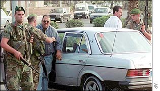 Lebanese troops check people during a street patrol near the Ain al-Helweh refugee camp 