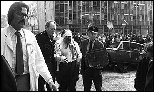 Barrister James Crespi being led away wounded and bandaged on 3 August 1973
