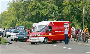 The peleton led by Galdeano in yellow passes the scene of an accident prior to the start of the 10th stage
