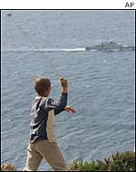Moroccan child aims slingshot at Spanish warship patrolling near Perejil island