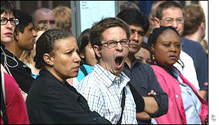 Travellers wait at a bus stop during London Underground strike