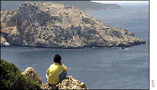 Moroccan child looks out to the island of Perejil
