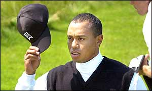Tiger doths his cap to the crowd of supporters