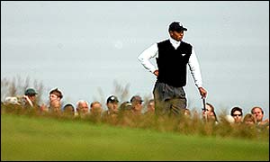 Woods stands in thought as he struggles to keep pace with playing partners Justin Rose and Shigeki Maruyama 