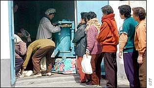 North Korean women queue for rice rations