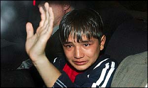 A tearful boy after he failed to get asylum in Britain