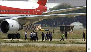Police and officials surrounding the plane