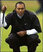 Tiger Woods sizes up a putt