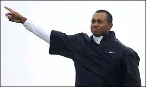 Tiger Woods points to the sky during a rare bad day for him