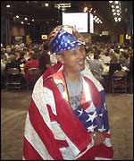 Flag-draped person at conference