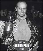 Juan Manuel Fangio with the trophy for winning the 1956 British Grand Prix