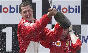 Michael Schumacher on the podium after winning the French Grand Prix