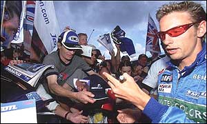 Button signs autographs for fans at Silverstone