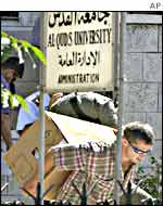 Israeli police carry boxes of documents from al-Quds University