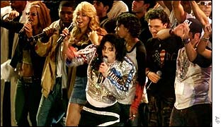 Michael Jackson, centre, is joined by the featured performers of United We Stand: What More Can I Give benefit concert during the finale 