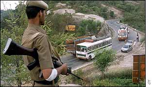 Indian soldier guards a road in Kashmir