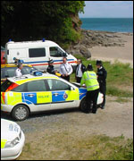 Police and coastguards on the beach