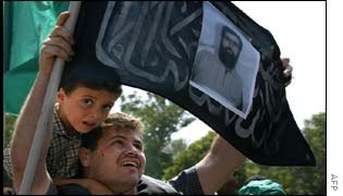 A Palestinian mourner carries a picture of Salah Shehade