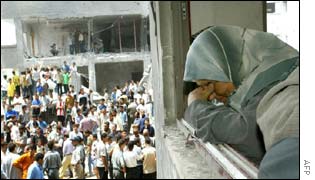 A woman, resident of the Al-Darg neighbourhood hit by an Israeli missile, cries from her window that looks onto the main area destroyed by the bombing