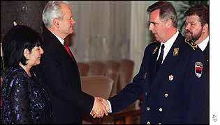 Rade Markovic (centre right) shakes hands with former Yugoslav President Slobodan Milosevic (centre left)